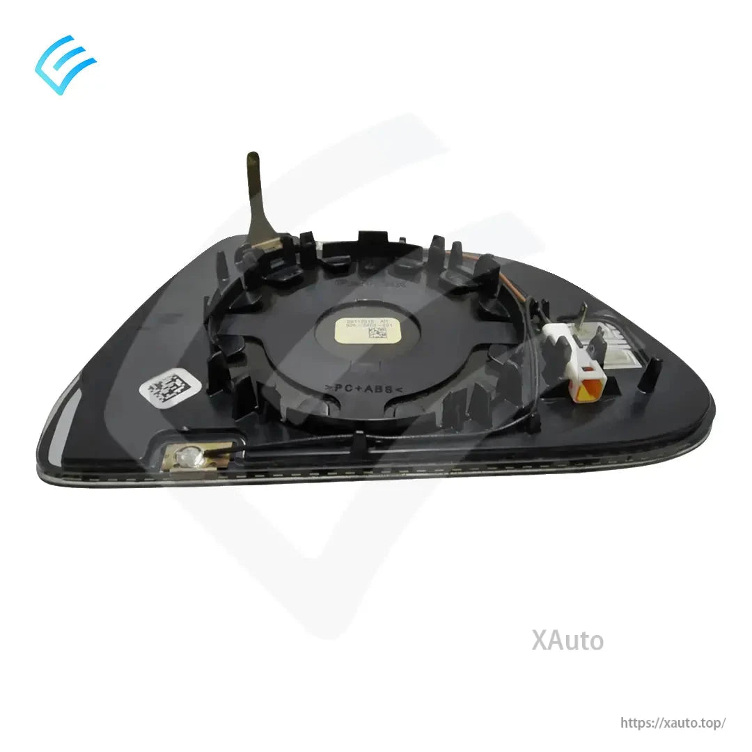 Angled rear view of mirror glass backing plate showing connector location and clip ring