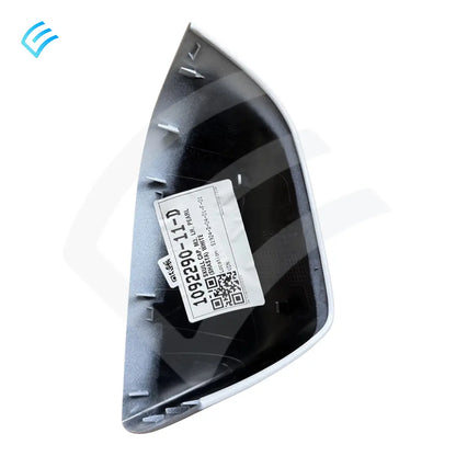 Back side of LH mirror skull cap showing mounting clips and OEM label sticker