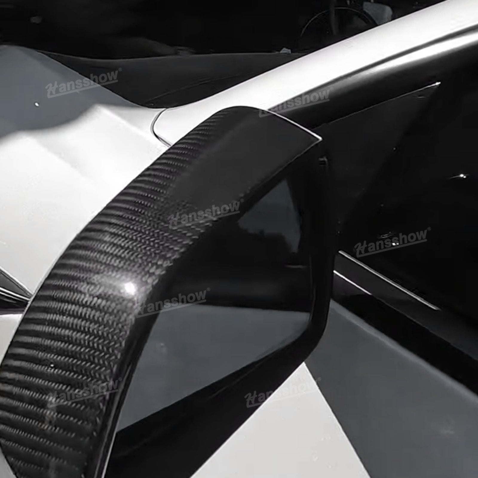 Side mirror cover shown from rear angle on white Tesla, highlighting curved edge and taper