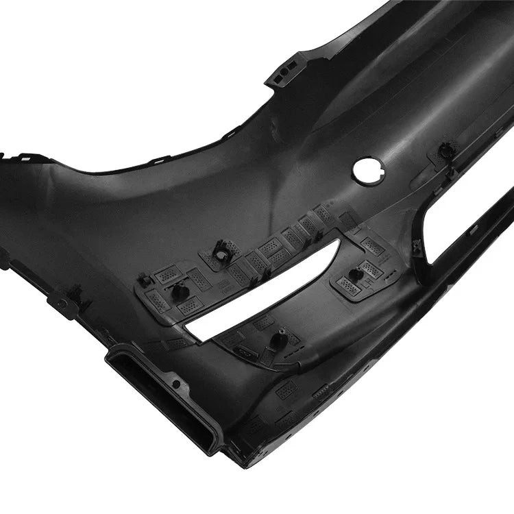 Inner side of Model Y front bumper cover showing mounting tabs, clip points, and molded brackets