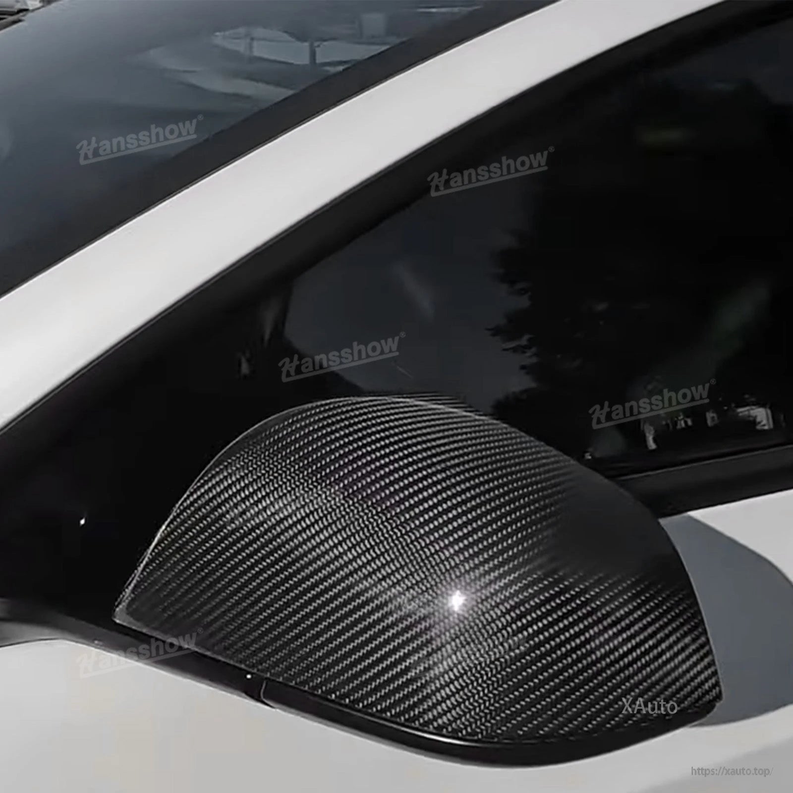 Installed mirror cover showing carbon fiber weave pattern on Tesla side mirror, medium close-up
