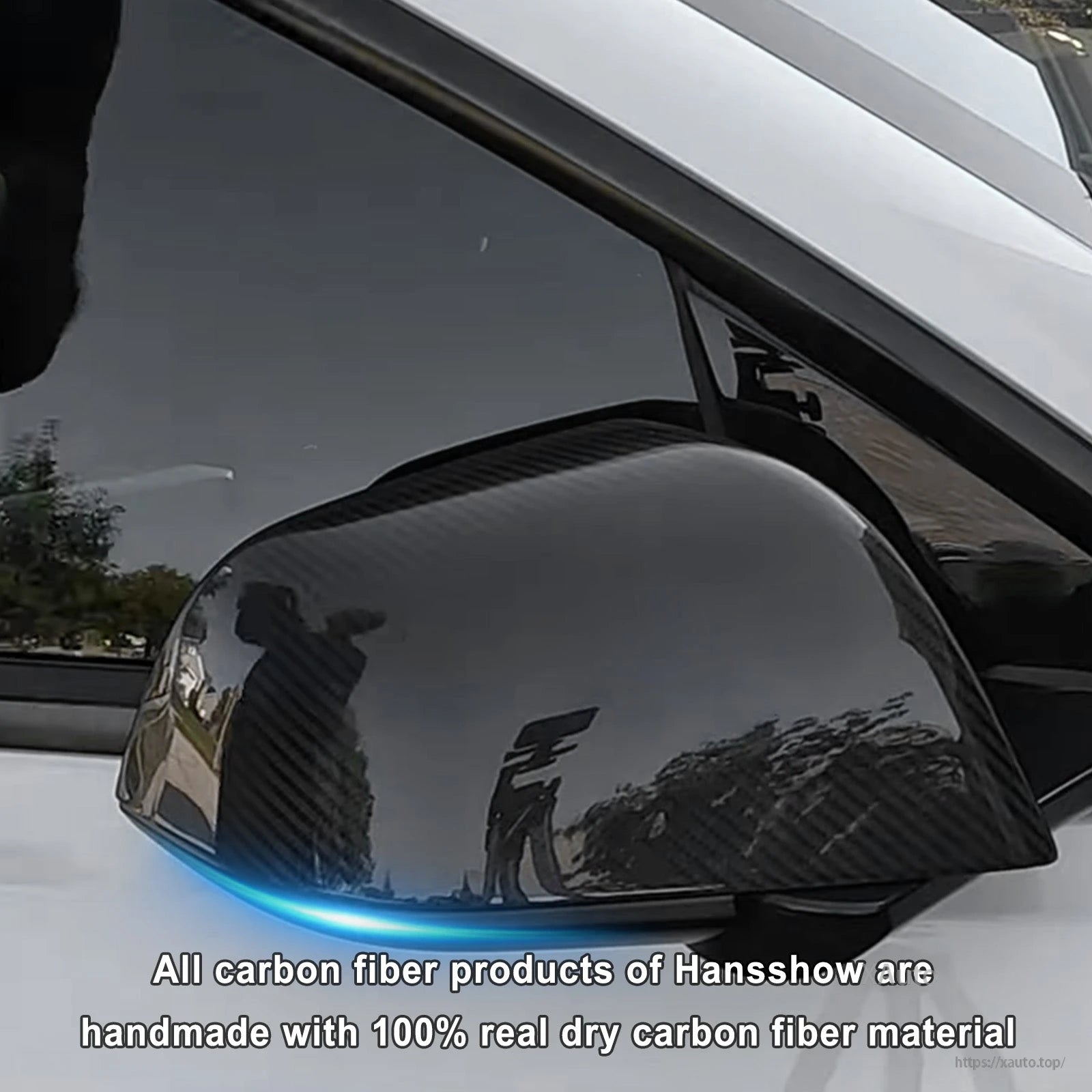 Gloss carbon fiber mirror cover installed on white Tesla, front quarter angle close-up
