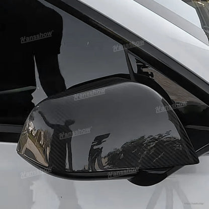 Gloss carbon fiber mirror cover installed view showing lower edge and front tip alignment