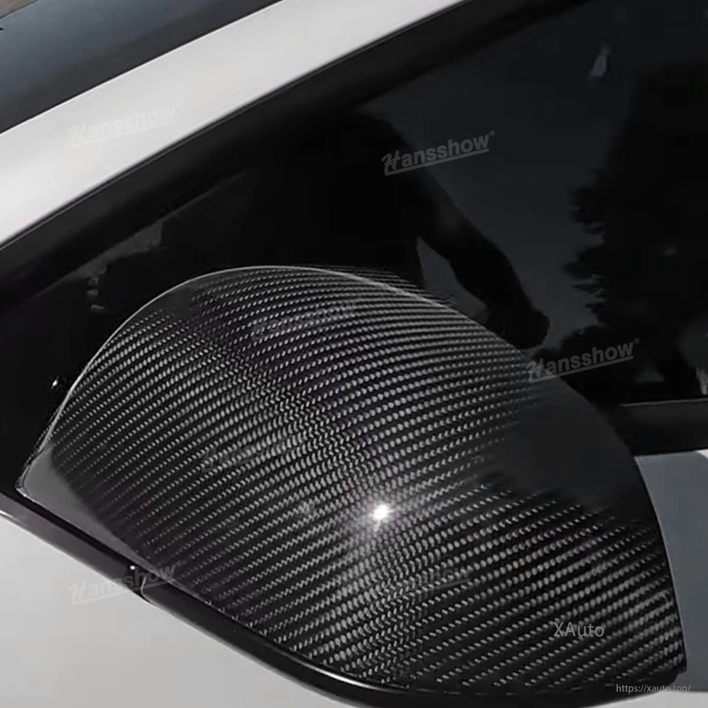 Extreme close-up of carbon fiber weave on installed mirror cap with glossy highlight