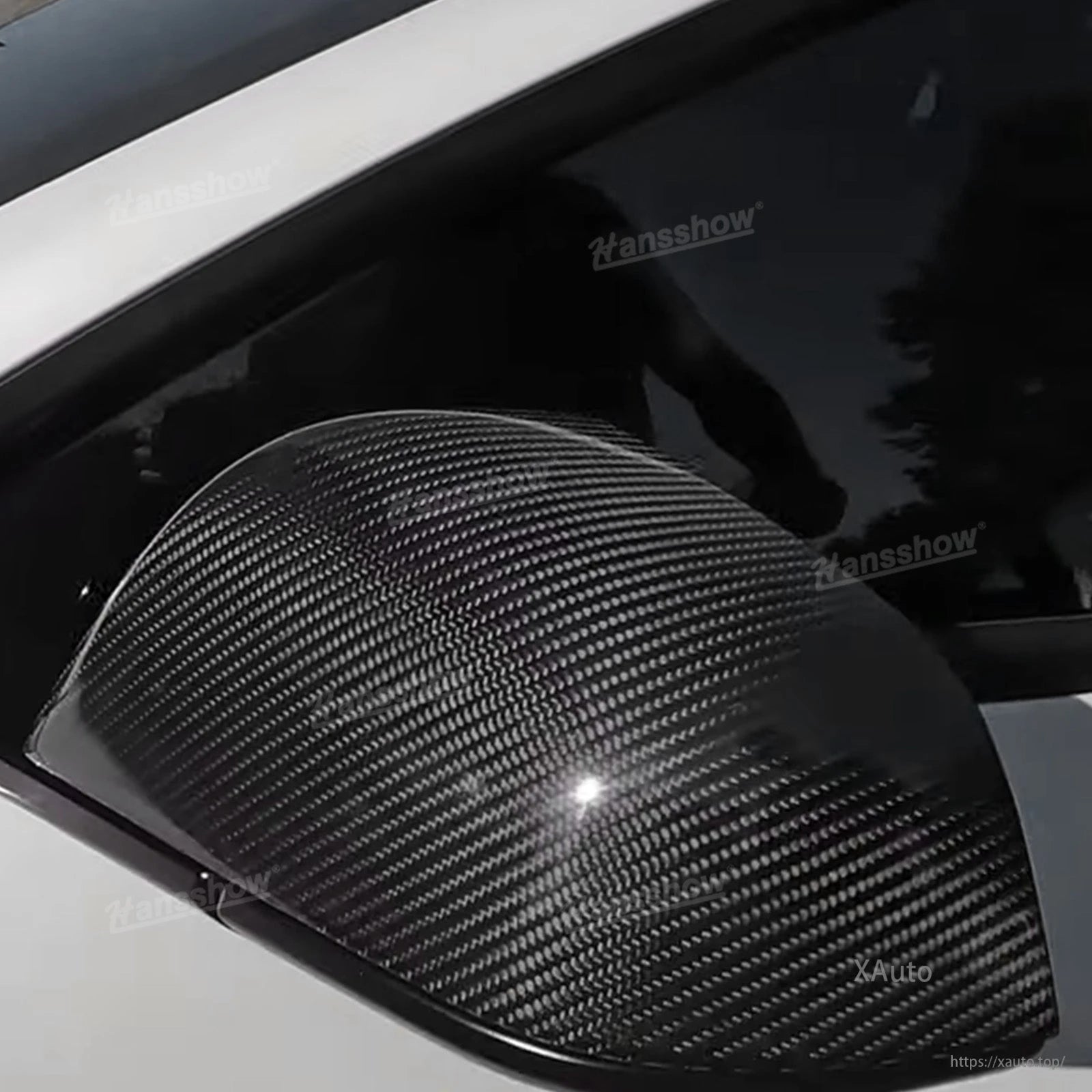 Extreme close-up of carbon fiber weave on installed mirror cap with glossy highlight