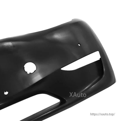 Front bumper corner detail with sensor hole and side vent opening, black finish close-up