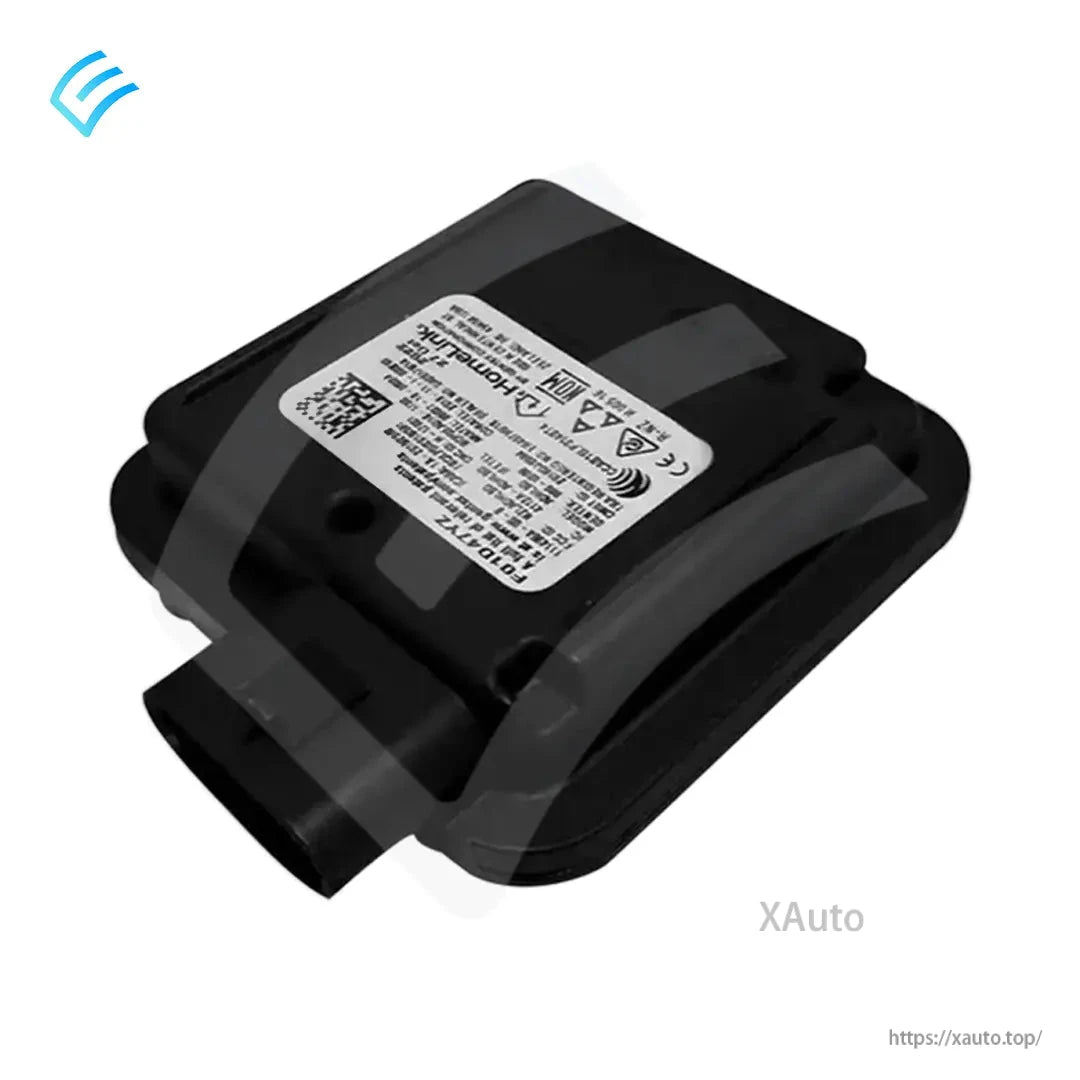 Angled side view of Tesla HomeLink garage door module with plug connector and printed ID label