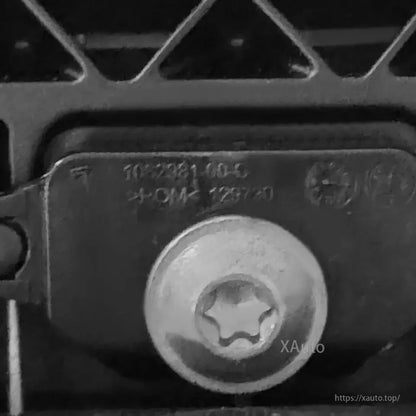 Close-up of mounting screw and stamped identification marking on the door handle assembly bracket