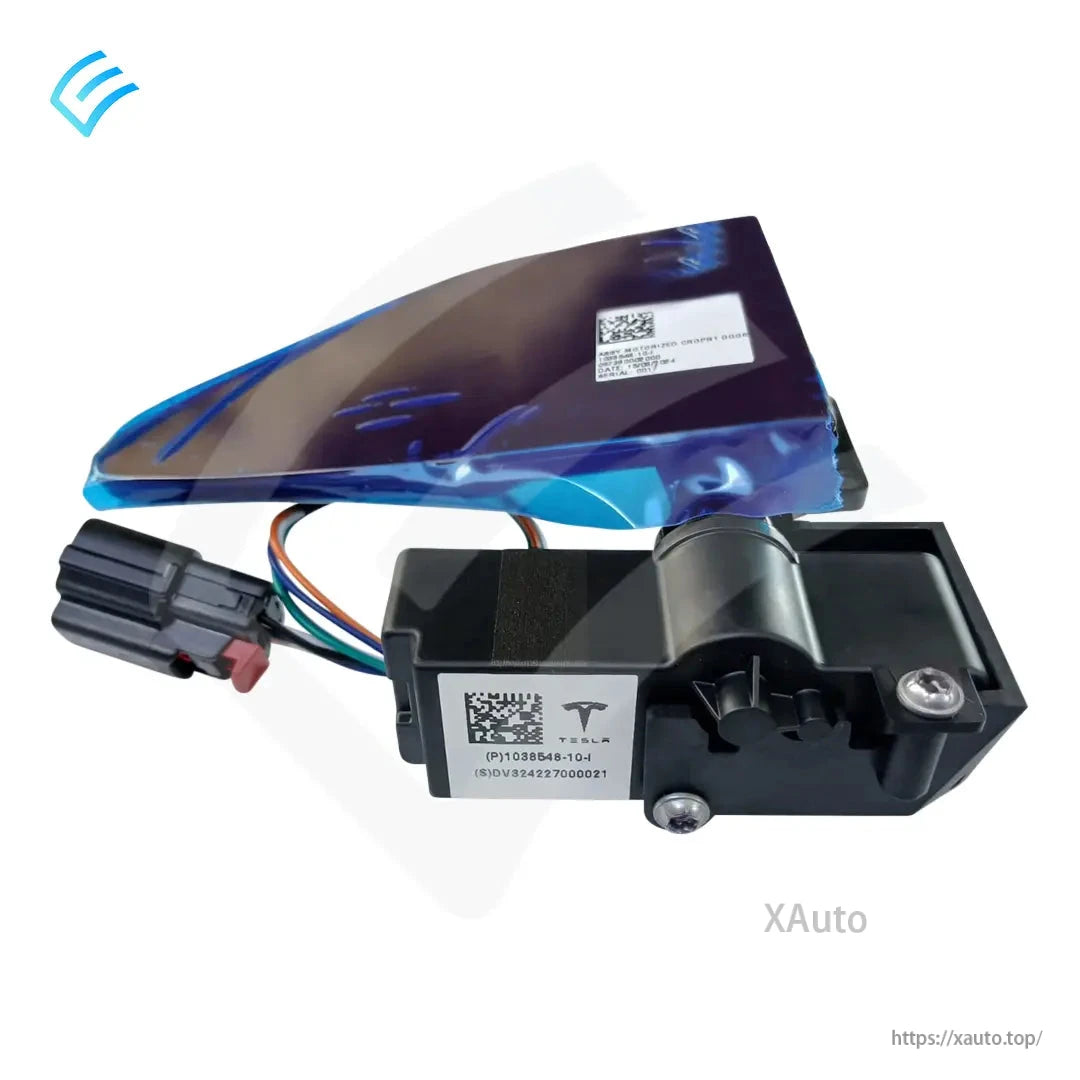 Close-up of motor housing and Tesla part label with wiring connector; charge port door panel under blue film