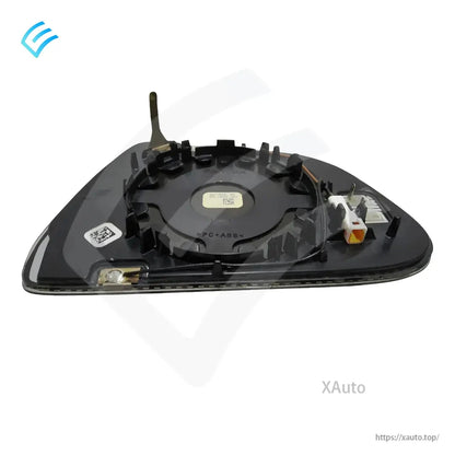 Angled rear view of mirror glass backing plate showing connector location and clip ring