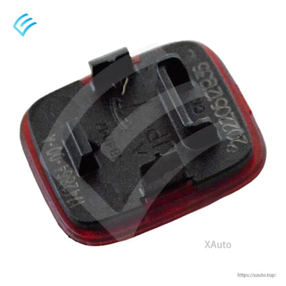 OEM door trim reflector back view, angled to show the mounting clips and housing depth