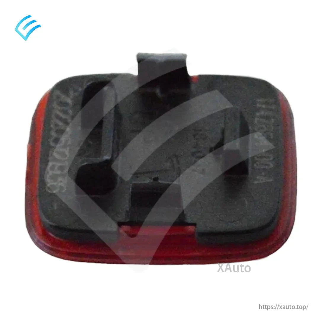 Rear side of OEM door trim reflector with clip mounts and black housing detail