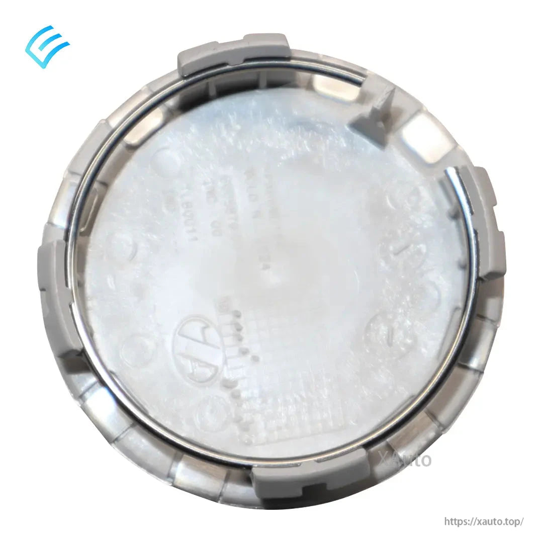 Rear view of Tesla center cap with retaining ring and molded inner markings around the edge